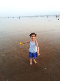 Boy on beach against sky