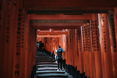 Rear view of people walking in temple