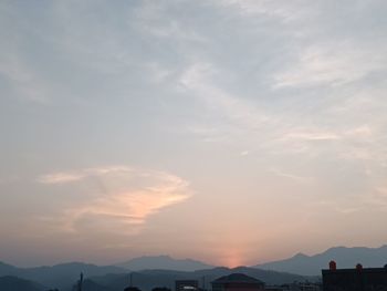 Scenic view of silhouette mountains against sky at sunset
