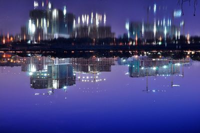 Aerial view of illuminated city against sky at night