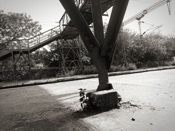 Man on bridge against sky