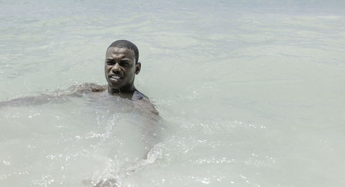 Portrait of woman swimming in sea