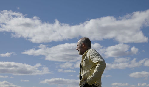 Low angle view of man standing against sky