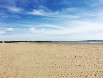 Scenic view of beach against blue sky