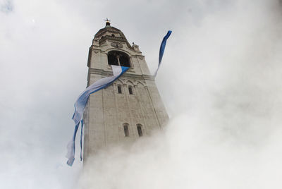 Low angle view of bell tower against sky