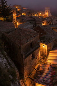 High angle view of illuminated buildings in city at night