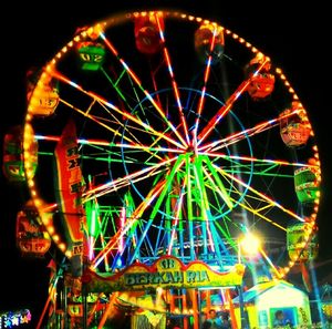 Low angle view of ferris wheel at night