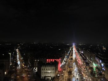 Illuminated city against sky at night