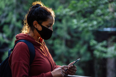 Young woman using mobile phone outdoors