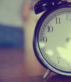 Close-up of alarm clock on table