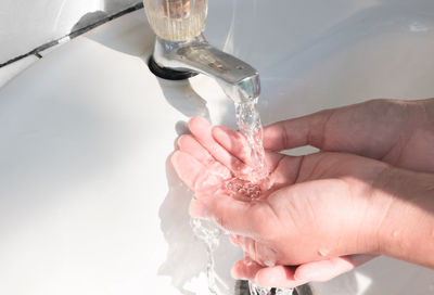 Close-up of hand holding splashing water