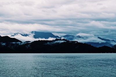 Scenic view of lake and mountains against sky