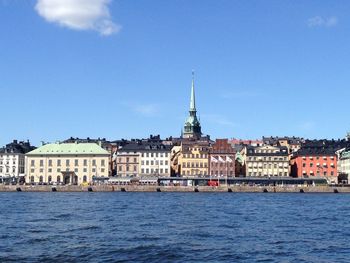 Buildings in city against blue sky