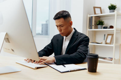 Side view of businessman working at office