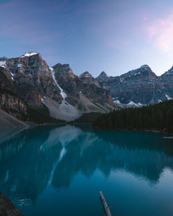 Scenic view of lake and mountains against blue sky