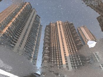 Reflection of buildings on wet glass