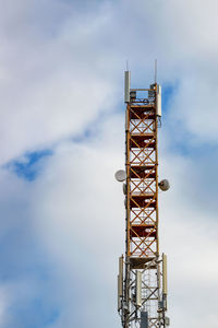 Low angle view of communications tower against sky