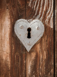 Close-up of heart shape on wooden door