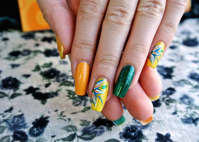 Close-up of woman fingers with colorful nail polish