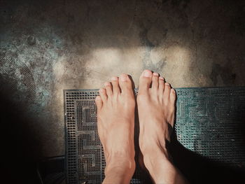 Low section of man on doormat