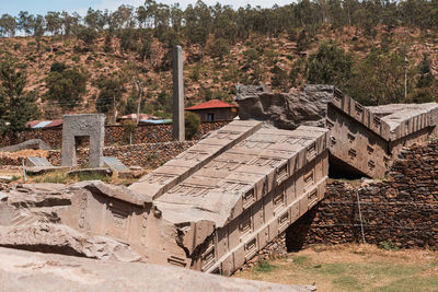 Old ruin on field against trees