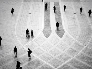 High angle view of silhouette people walking in town square