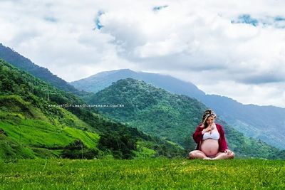 Portrait of woman on landscape against mountains