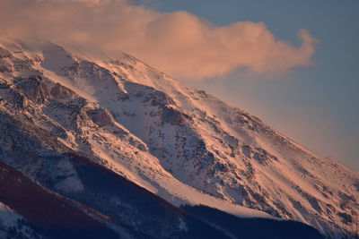 Scenic view of snowcapped mountains against sky during sunset