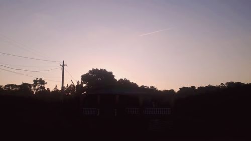 Silhouette trees against sky during sunset