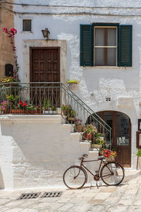 Bicycle against white building