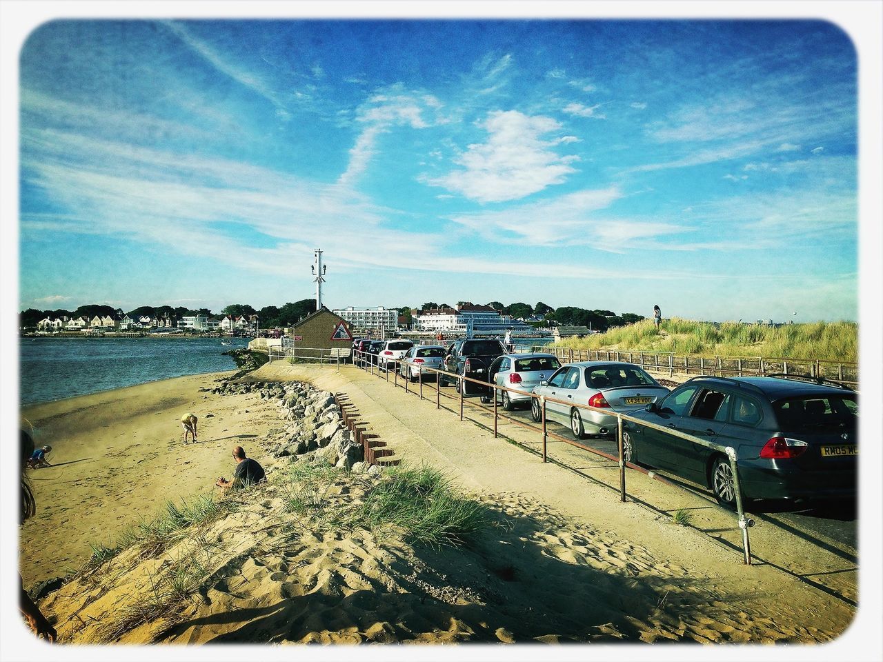 transfer print, sky, beach, auto post production filter, sea, transportation, water, sand, cloud - sky, the way forward, building exterior, built structure, road, cloud, blue, diminishing perspective, architecture, incidental people, shore, day