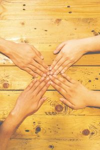 High angle view of hands on table