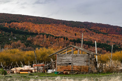 House on field against mountain