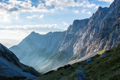 Scenic view of mountains against cloudy sky