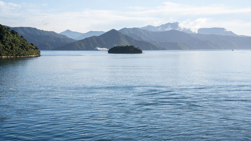 Big transport ship ferry sailing through green fjords, new zealand