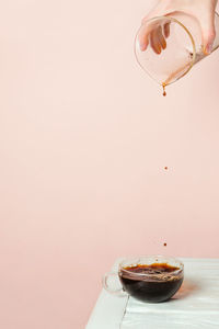 Close-up of coffee cup on table against wall