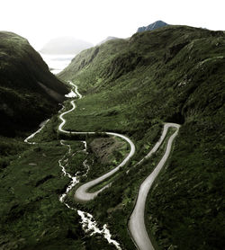 Winding road on mountain against sky