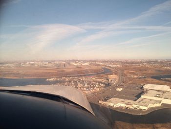 Cropped image of airplane flying over landscape