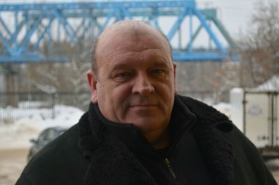 Portrait of mature man against bridge during winter