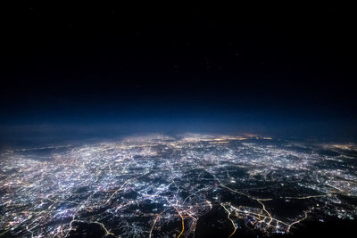 High angle view of city lit up at night