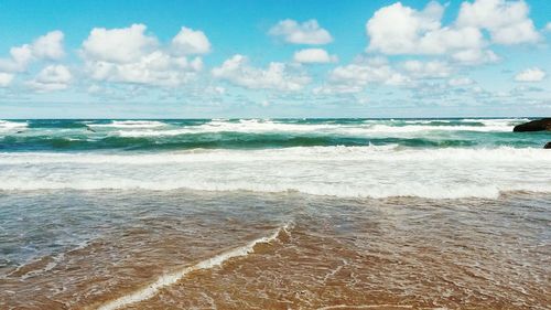 Scenic view of sea against cloudy sky