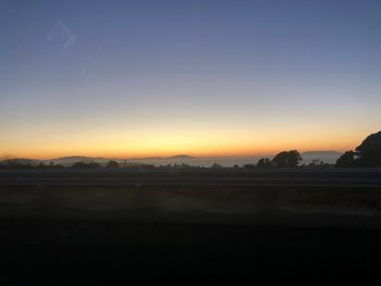 Scenic view of silhouette landscape against clear sky during sunset