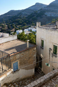 High angle view of townscape by mountain against sky