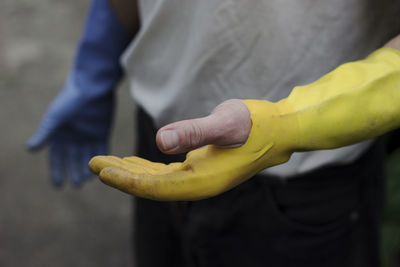 Midsection of man holding fruit