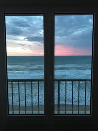 Scenic view of sea against sky seen through window