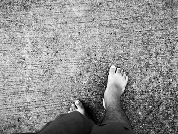 Low section of woman standing on road