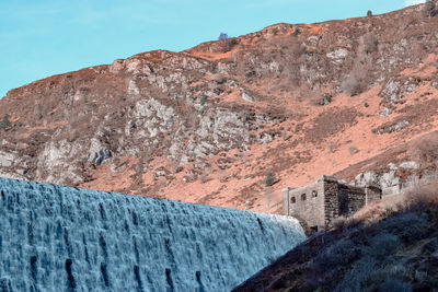 Low angle view of dam on mountain