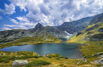 Scenic view of lake and mountains against sky