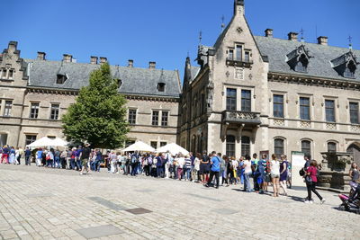 Group of people in front of buildings