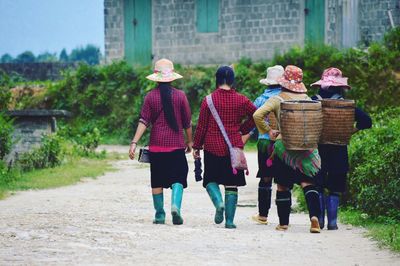 Rear view of people walking in basket